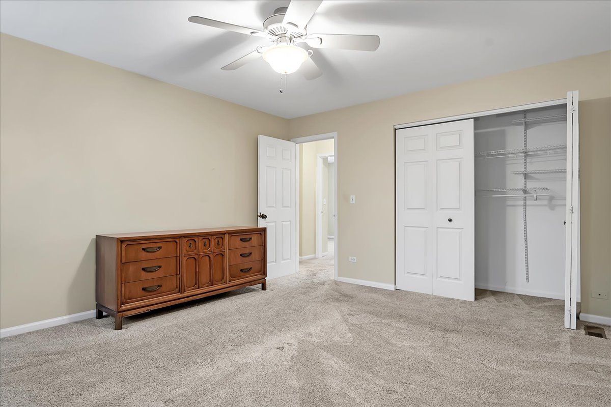 2591 Smithfield Lane Aurora, IL 60503 - Photo 16 of 31 a view of an empty room with cabinet and a ceiling fan