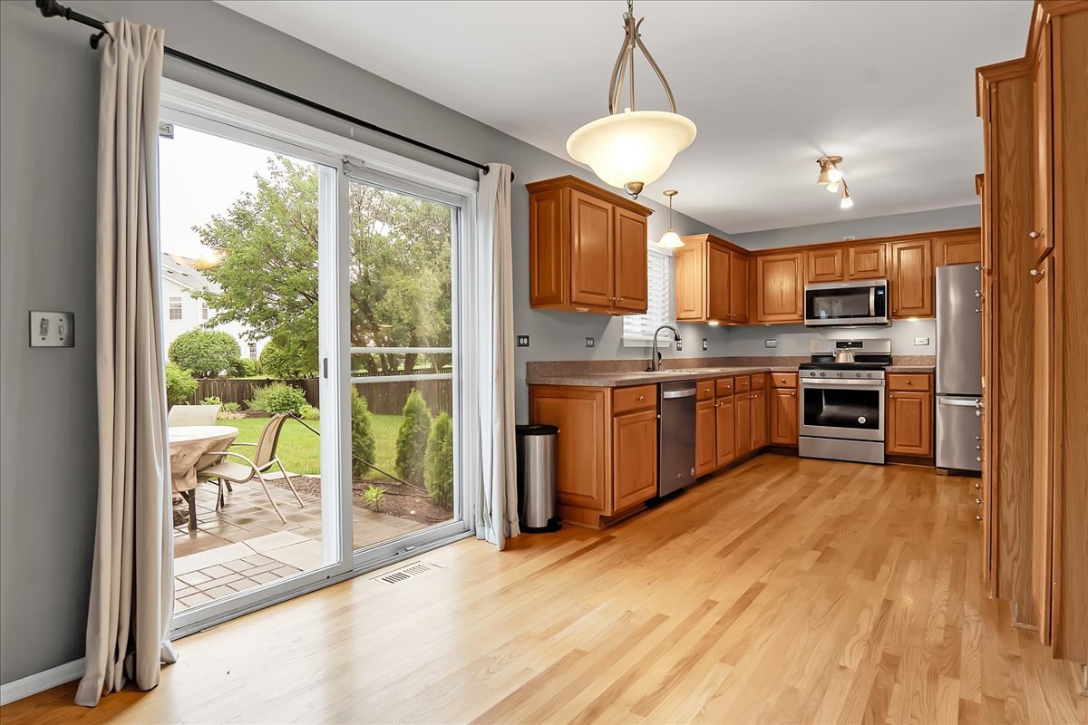 2591 Smithfield Lane Aurora, IL 60503 - Photo 2 of 31 a kitchen with stainless steel appliances granite countertop a stove and a refrigerator