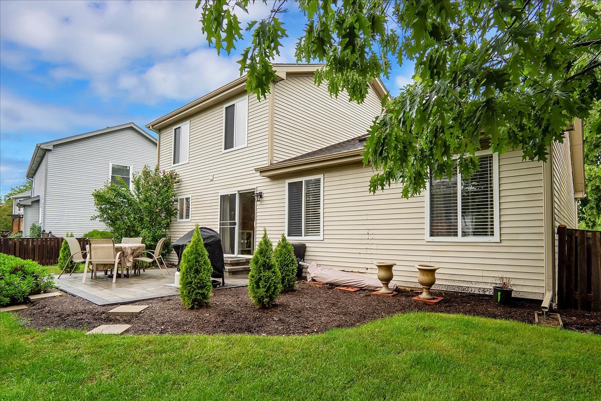 2591 Smithfield Lane Aurora, IL 60503 - Photo 28 of 31 a backyard of a house with potted plants and a bench