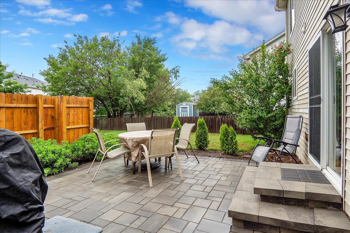 2591 Smithfield Lane Aurora, IL 60503 - Photo 29 of 31 a view of backyard with seating area and trees