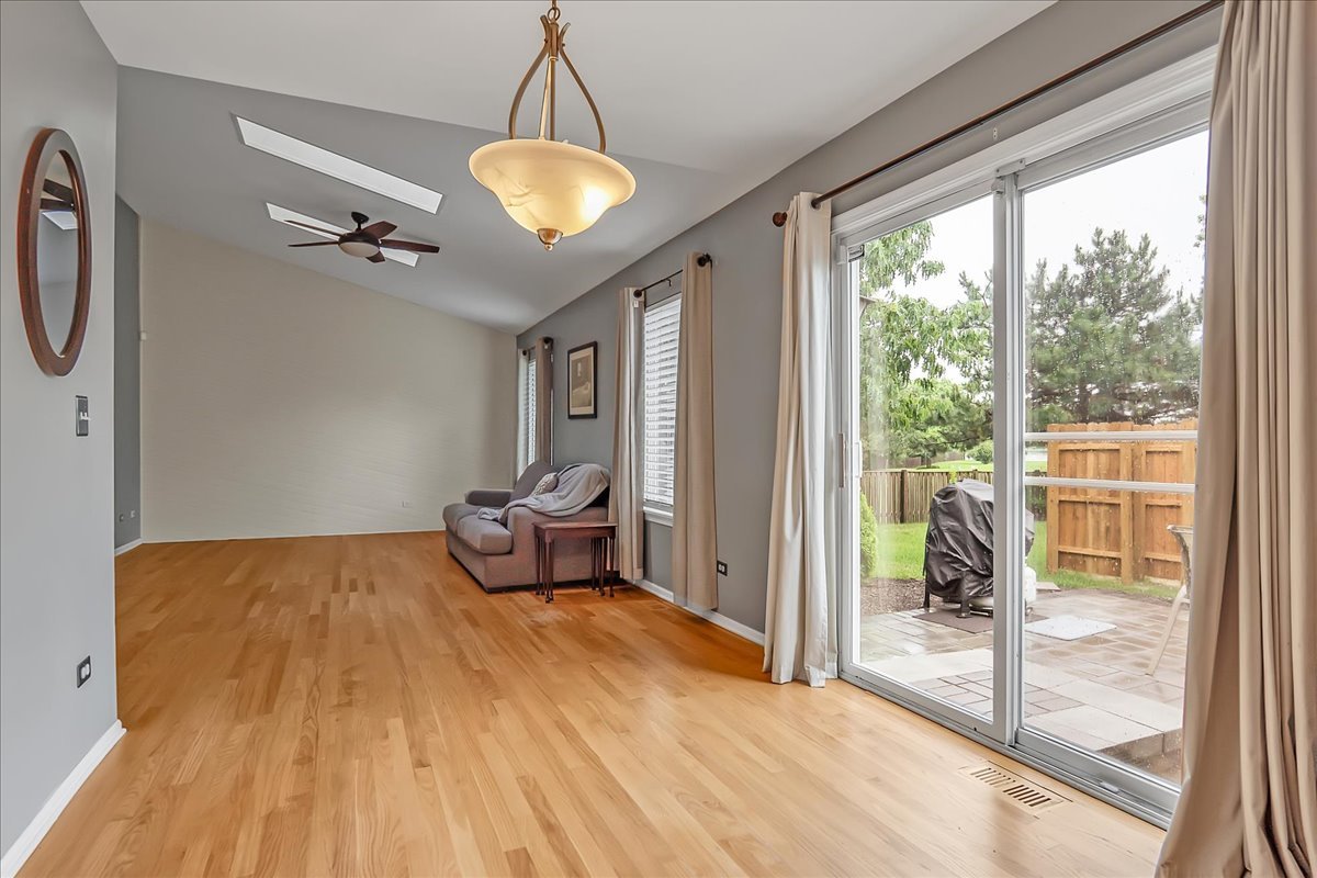 2591 Smithfield Lane Aurora, IL 60503 - Photo 8 of 31 a bedroom with a bed and a chandelier