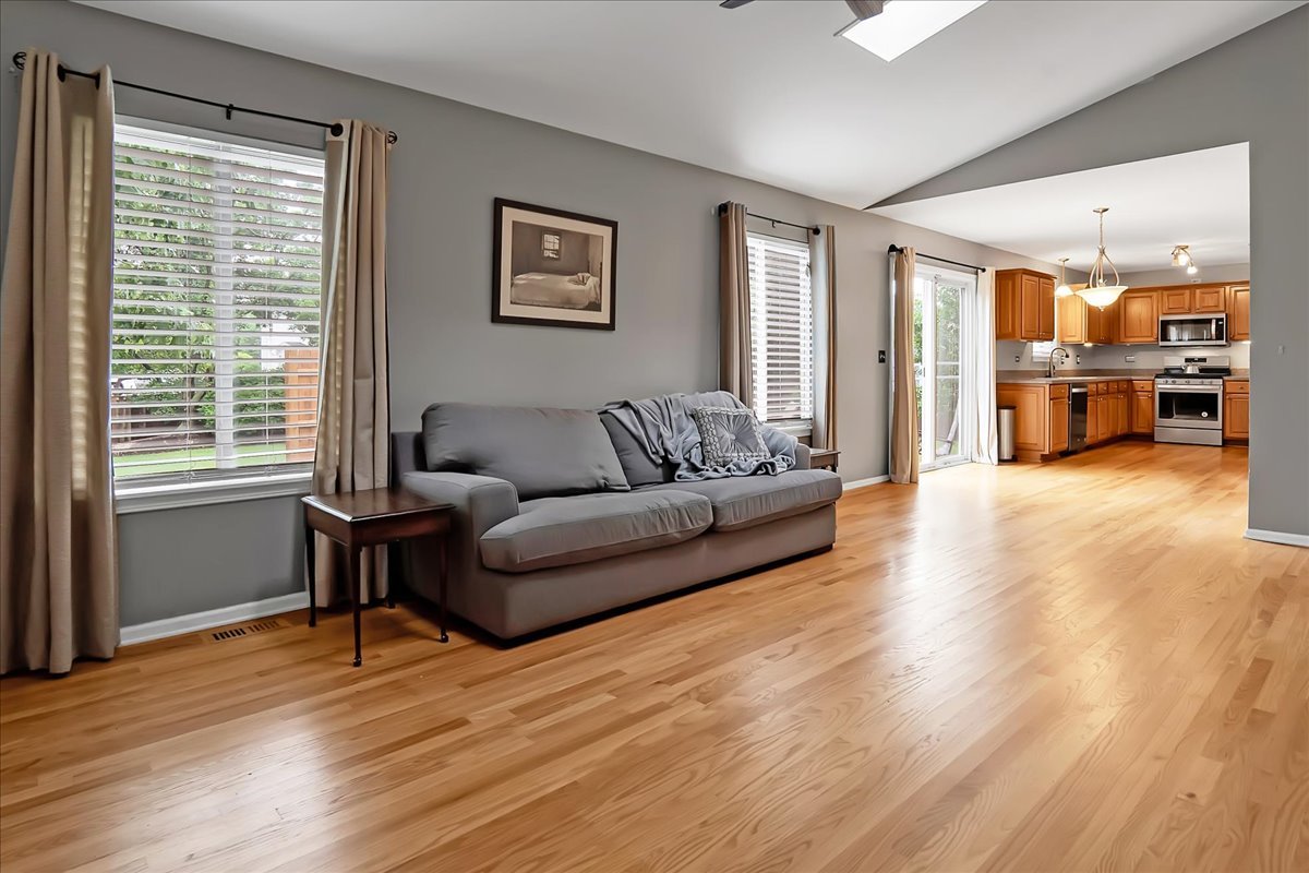 2591 Smithfield Lane Aurora, IL 60503 - Photo 10 of 31 a living room with furniture and a wooden floor