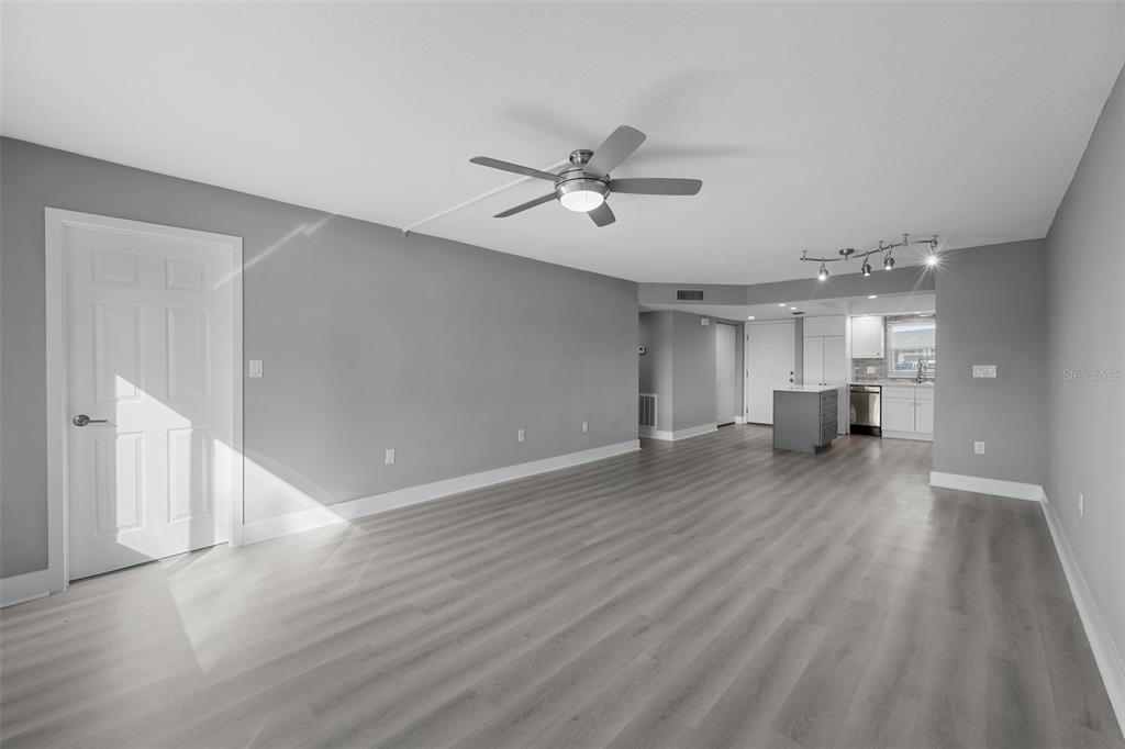 4775 Cove Circle, Unit 103 St. Petersburg, FL 33708 - Photo 11 of 61 a view of empty room with wooden floor and window