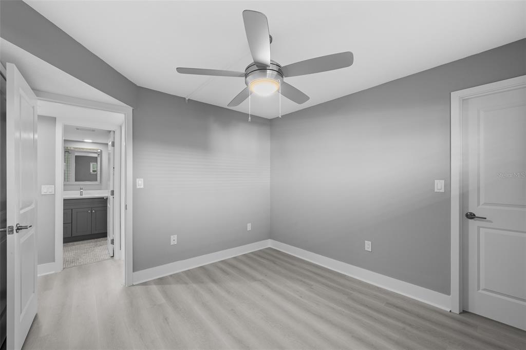 4775 Cove Circle, Unit 103 St. Petersburg, FL 33708 - Photo 16 of 61 wooden floor in an empty room and a window