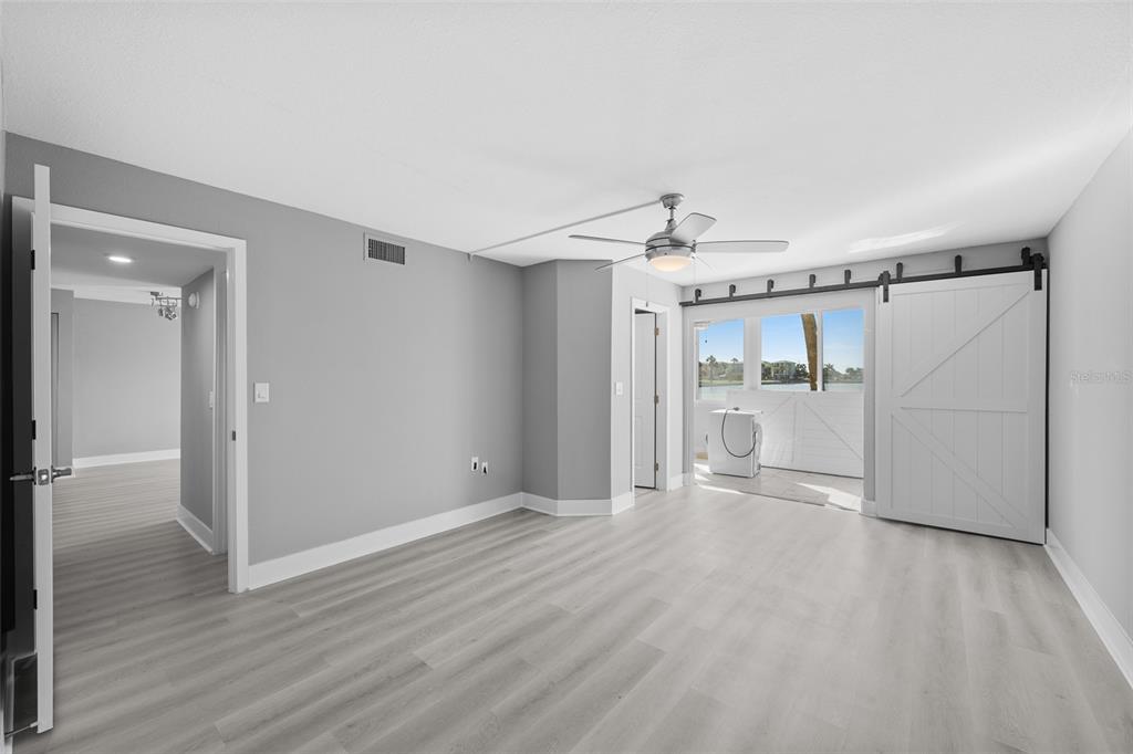 4775 Cove Circle, Unit 103 St. Petersburg, FL 33708 - Photo 22 of 61 a view of a room with wooden floor and window