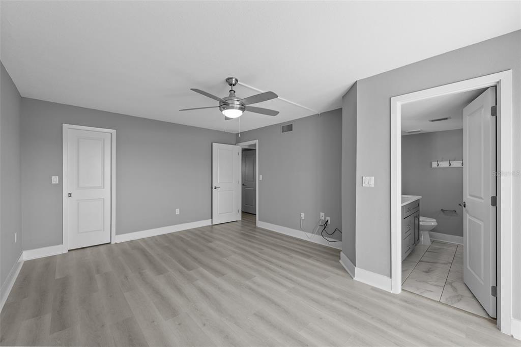 4775 Cove Circle, Unit 103 St. Petersburg, FL 33708 - Photo 24 of 61 wooden floor in an empty room with a bathroom