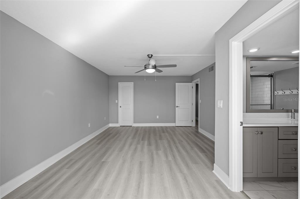 4775 Cove Circle, Unit 103 St. Petersburg, FL 33708 - Photo 25 of 61 wooden floor in an empty room with a window
