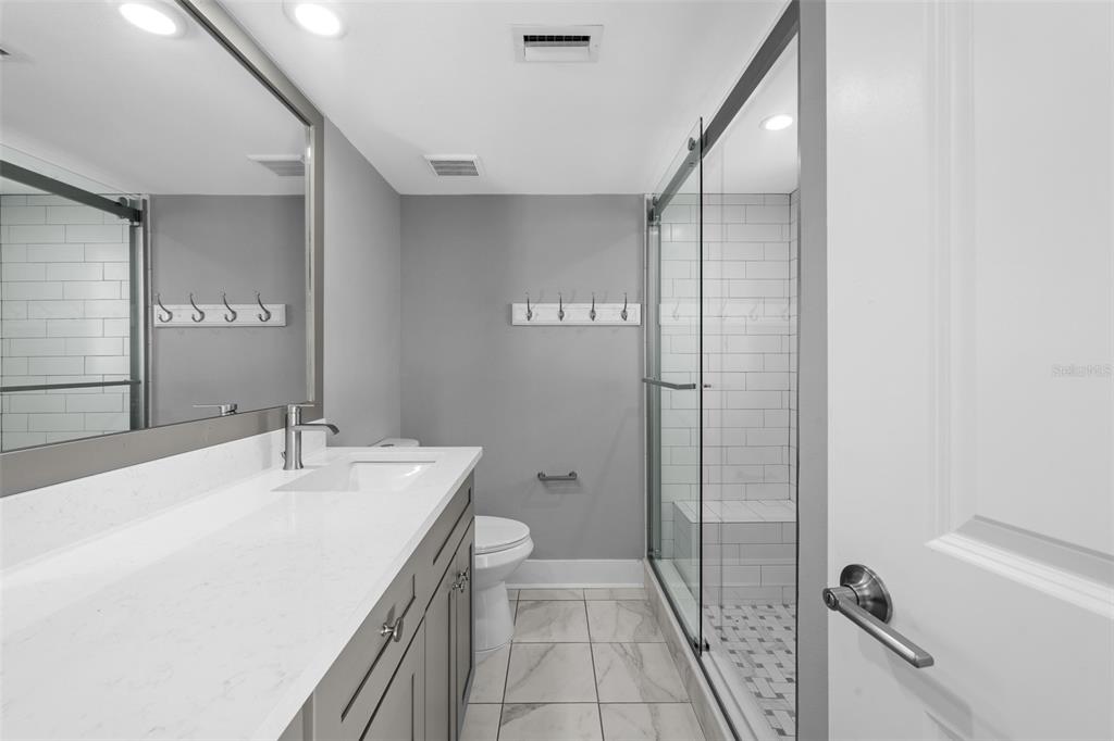 4775 Cove Circle, Unit 103 St. Petersburg, FL 33708 - Photo 26 of 61 a bathroom with a sink a toilet and shower