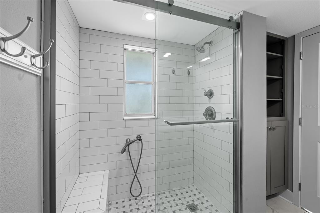 4775 Cove Circle, Unit 103 St. Petersburg, FL 33708 - Photo 29 of 61 a bathroom with a shower