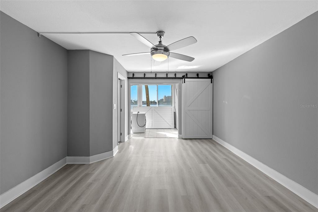 4775 Cove Circle, Unit 103 St. Petersburg, FL 33708 - Photo 30 of 61 wooden floor in an empty room with a window
