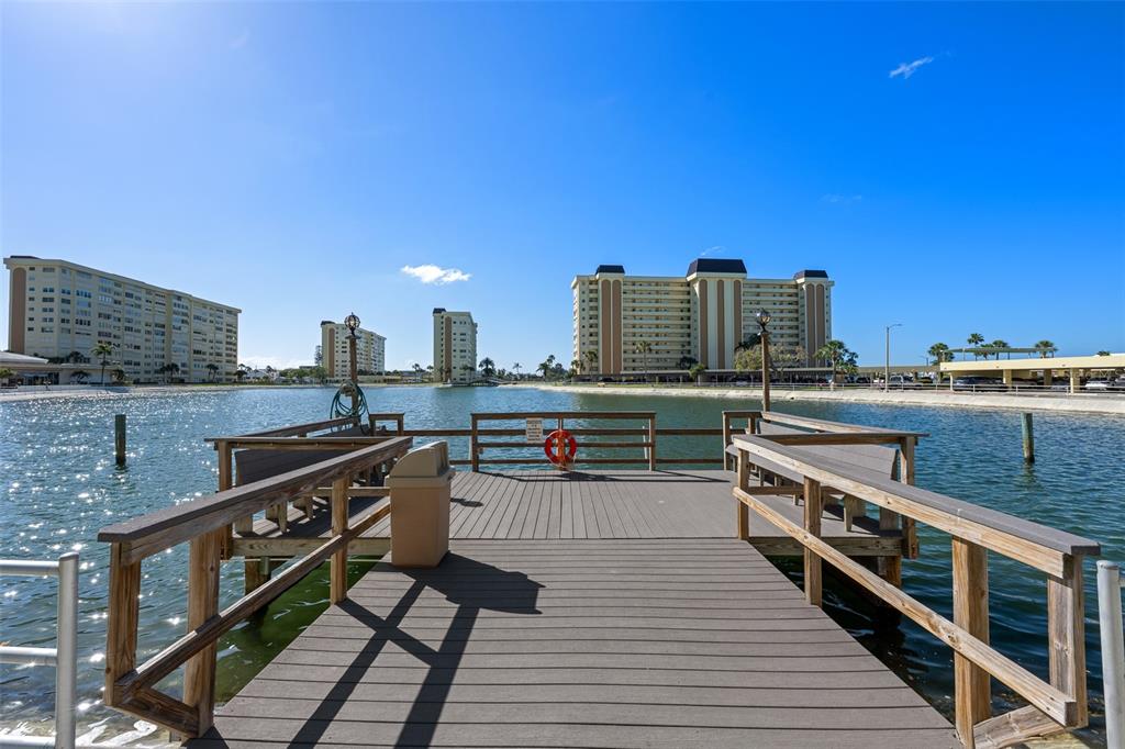 4775 Cove Circle, Unit 103 St. Petersburg, FL 33708 - Photo 38 of 61 a view of a balcony with wooden floor and outdoor seating