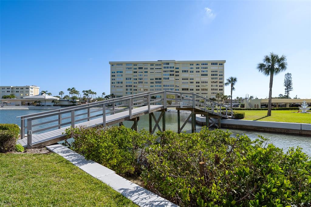 4775 Cove Circle, Unit 103 St. Petersburg, FL 33708 - Photo 40 of 61 a view of a swimming pool with a lounge chairs