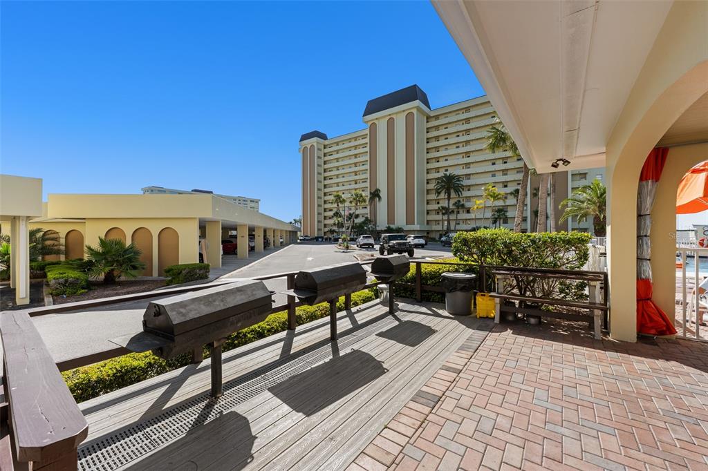 4775 Cove Circle, Unit 103 St. Petersburg, FL 33708 - Photo 42 of 61 a view of balcony with chairs and wooden floor