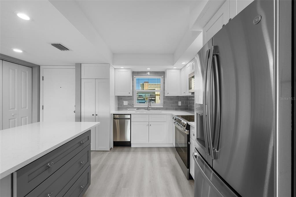 4775 Cove Circle, Unit 103 St. Petersburg, FL 33708 - Photo 5 of 61 a kitchen with a sink stove and refrigerator