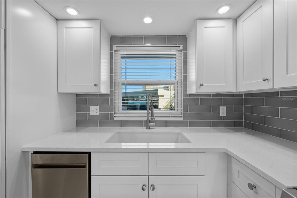 4775 Cove Circle, Unit 103 St. Petersburg, FL 33708 - Photo 7 of 61 a kitchen with a sink and cabinets