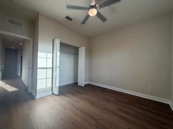 a dining room with furniture and a floor to ceiling window