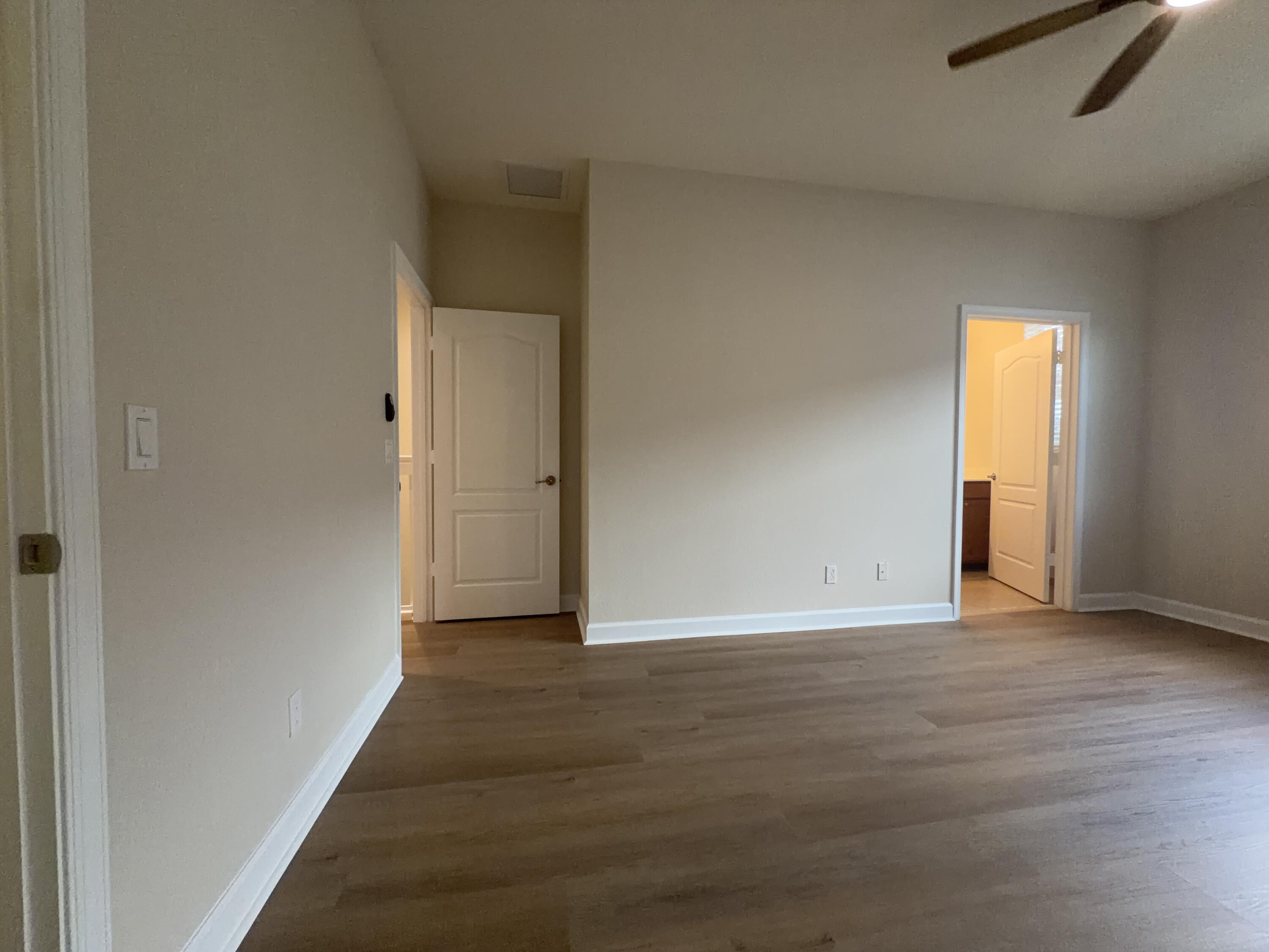 9491 Southwest Merlin Court Stuart, FL 34997 - Photo 26 of 45 a view of an empty room with wooden floor and closet