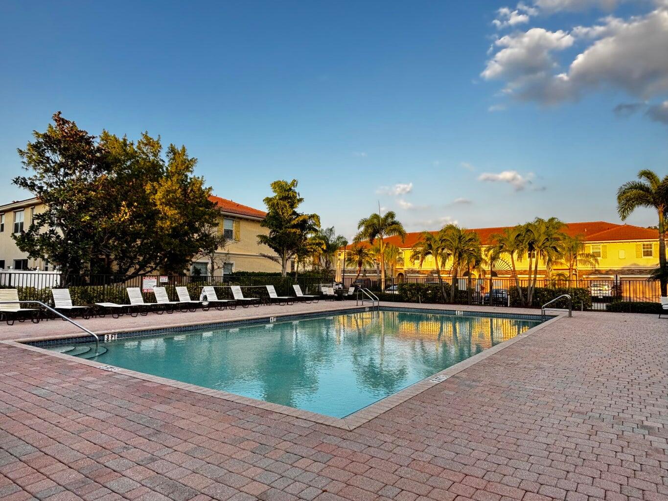 9491 Southwest Merlin Court Stuart, FL 34997 - Photo 40 of 45 a view of a swimming pool with an outdoor space and seating area