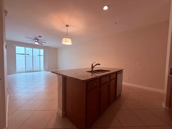 a view of an empty room with wooden floor and window