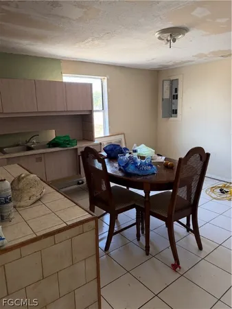 a room with furniture a refrigerator and a table