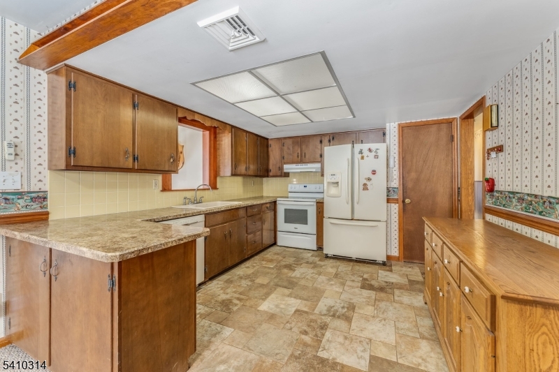 252 Mountain View Road West Asbury, NJ 08802 - Photo 4 of 28 a kitchen with stainless steel appliances granite countertop a refrigerator sink and cabinets