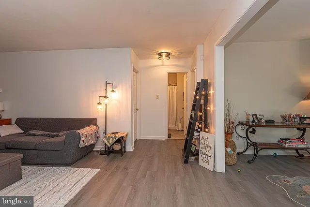 a living room with furniture and a wooden floor