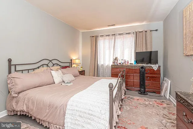 a bedroom with a bed and flat screen tv