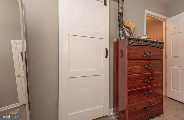 walk in closet with wooden floor