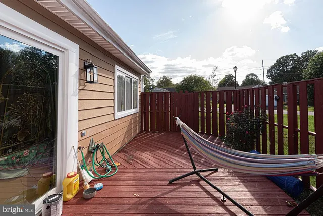 a view of deck with chairs and wooden floor