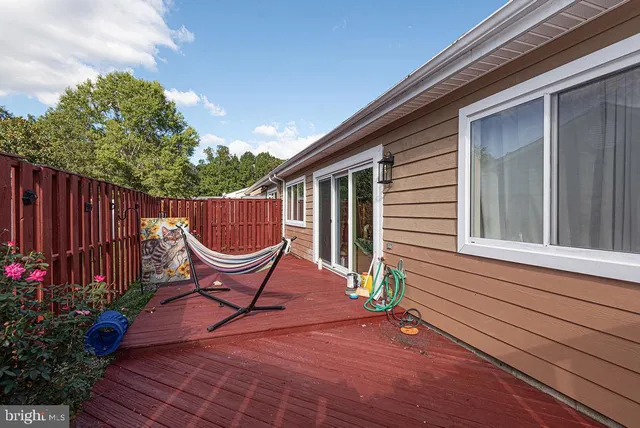 a wooden bench sitting in front of a house
