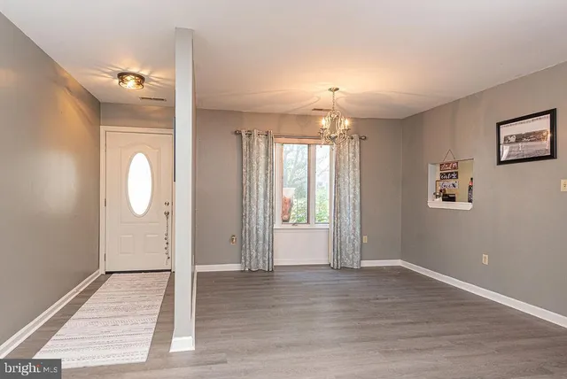 a view of a room with wooden floor and window