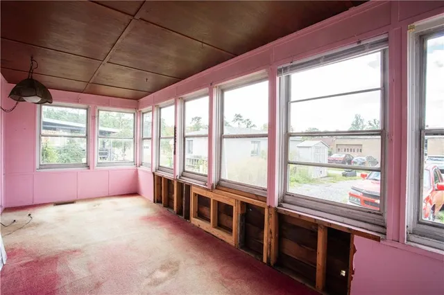 a big room with wooden floor and windows