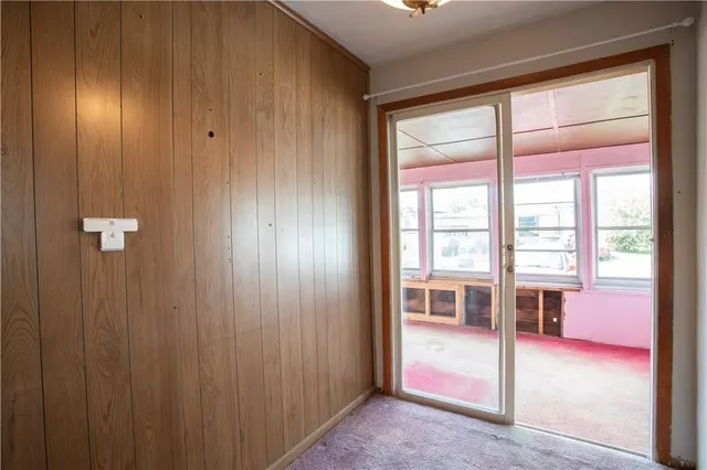 a view of a hallway with furniture and a window