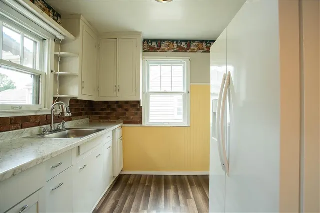 a kitchen with a sink and windows