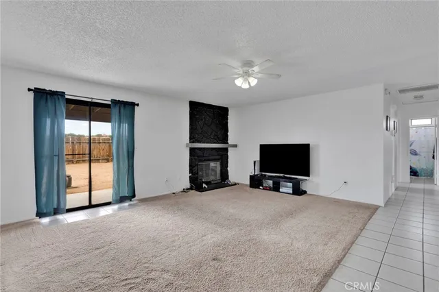 a view of a livingroom with an empty space and a window