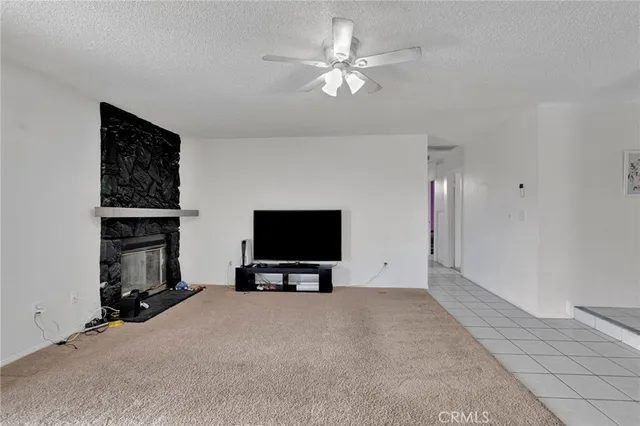 a view of livingroom with workspace and a ceiling fan