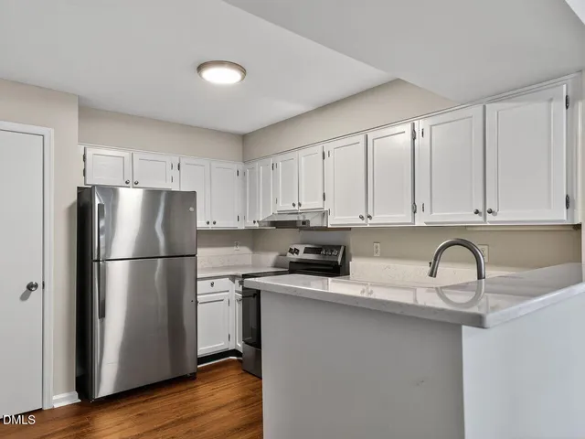 a kitchen with a refrigerator a stove a microwave and cabinets