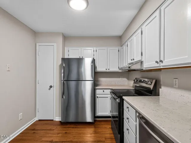 a view of kitchen with wooden floor and refrigerator