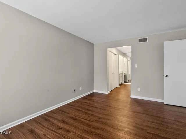 a view of walk in closet with empty racks