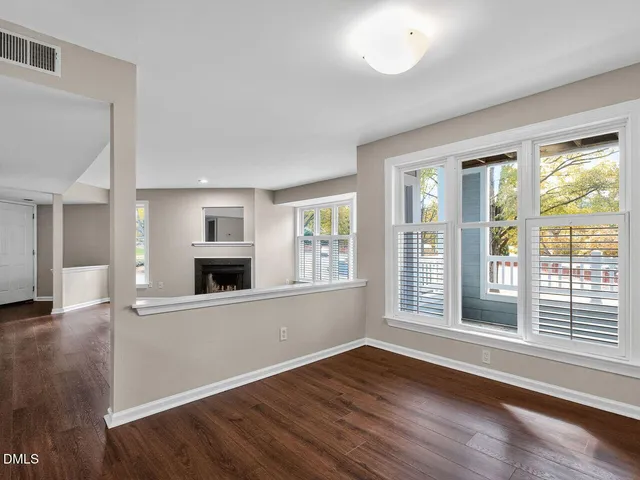 a view of a kitchen with wooden floor and electronic appliances
