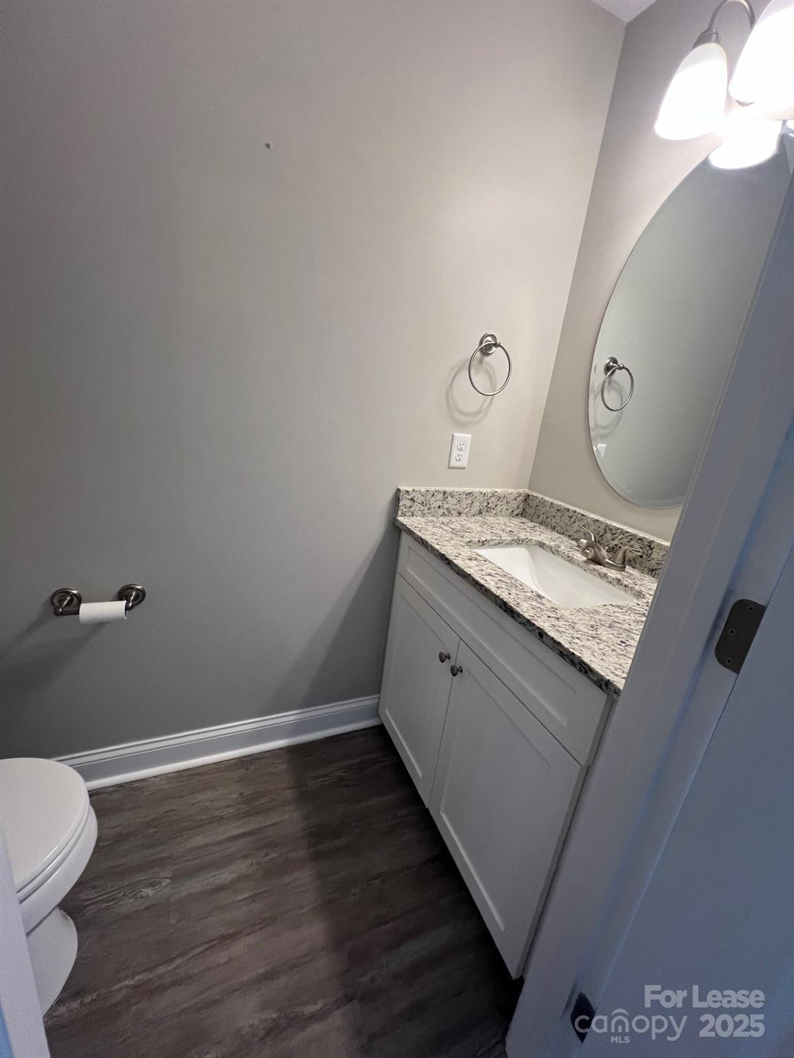 1086 20th Street Northeast Hickory, NC 28601 - Photo 5 of 14 a bathroom with a granite countertop sink and a toilet