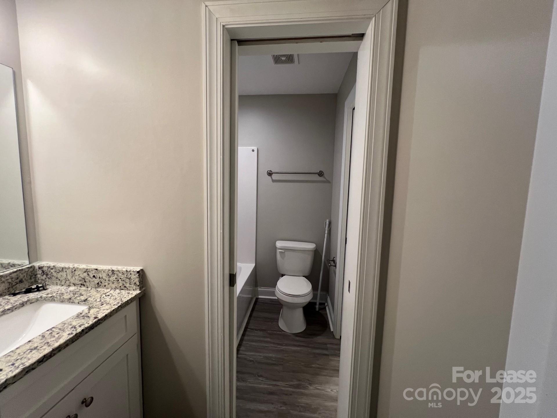 1086 20th Street Northeast Hickory, NC 28601 - Photo 8 of 14 a bathroom with a granite countertop sink and a toilet