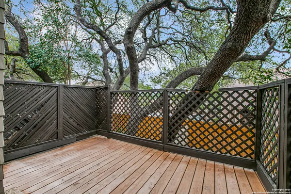 a view of wooden deck with a trees