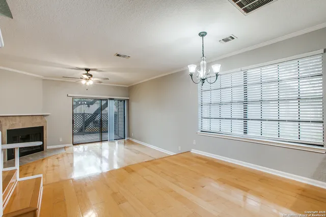 a view of an empty room with a fireplace and a window