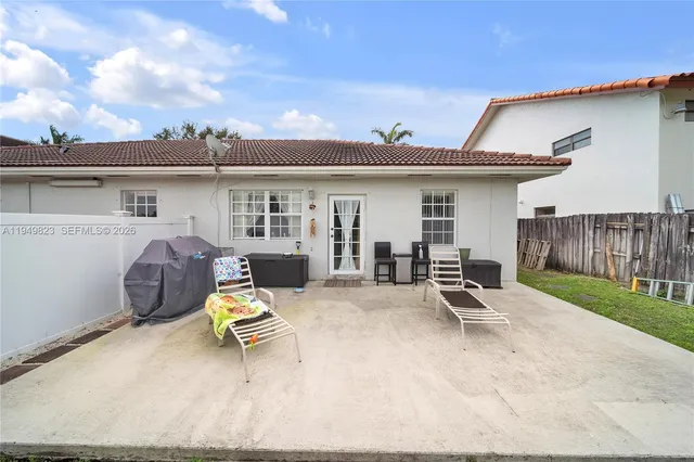 a view of a patio with a table and chairs