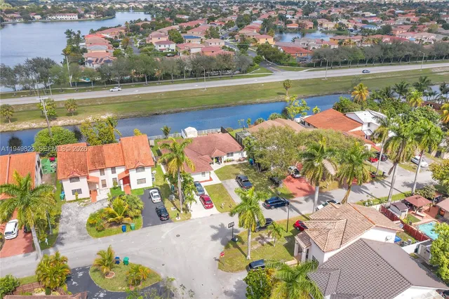 an aerial view of a house with a swimming pool patio and outdoor seating