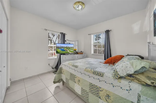 a bedroom that has a bed and a desk in it