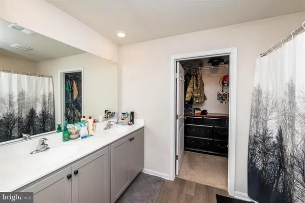 a en suite bathroom with a sink double vanity and a mirror
