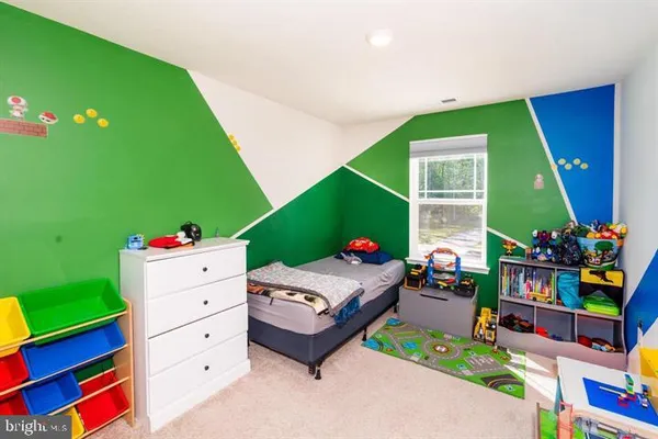 a bedroom with a bed and a dresser
