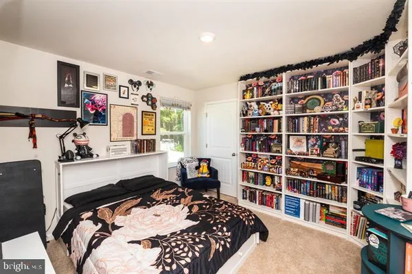 a bedroom with a bed and a book shelf
